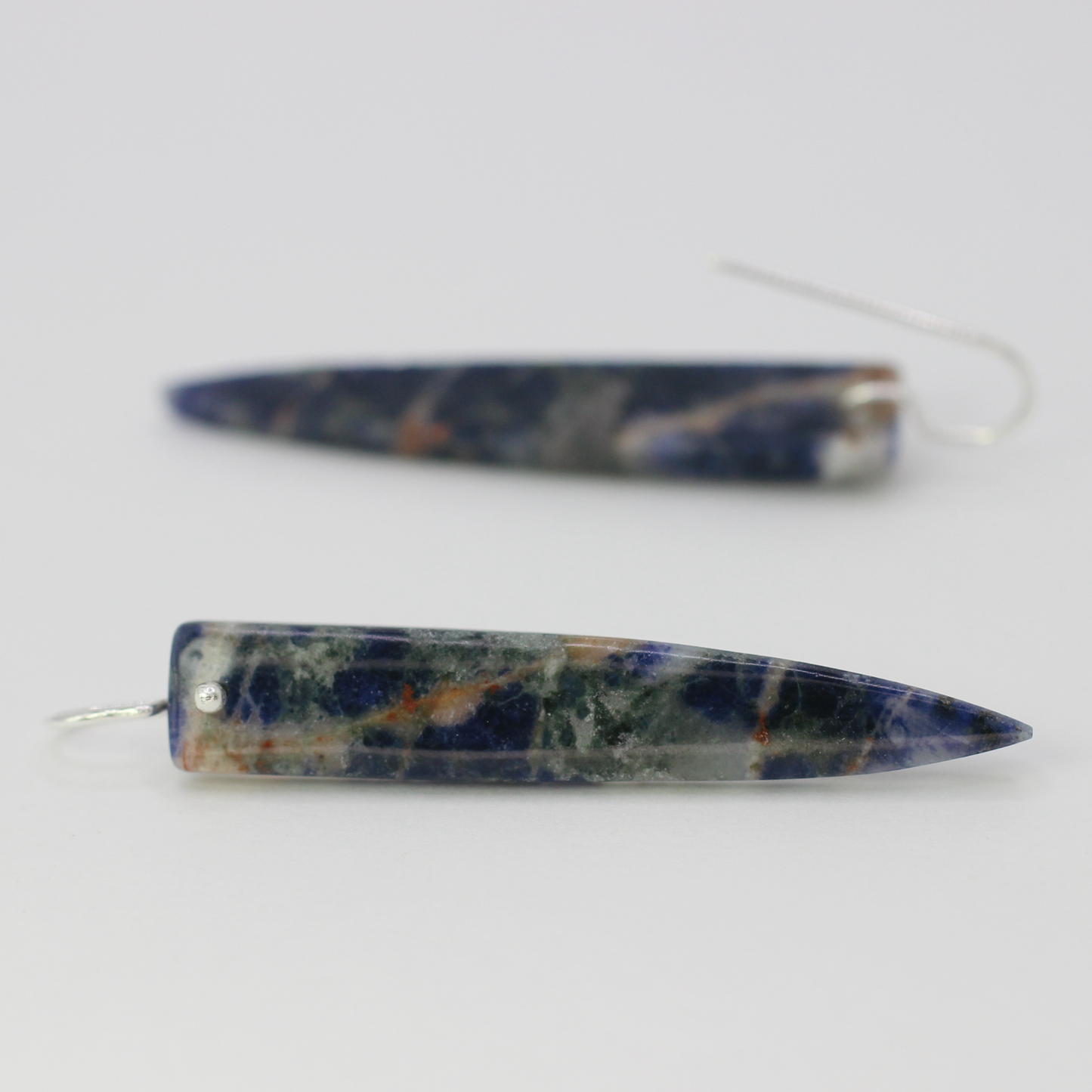 Orange sodalite spike earrings